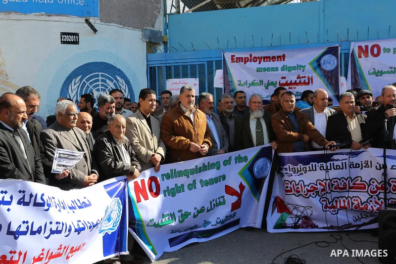 Palestinian employees of United Nations Relief and Works Agency (UNRWA) take part in a protest demanding their rights, outside its headquarter office, in Gaza City on November 25, 2018. Photo by Ashraf Amra