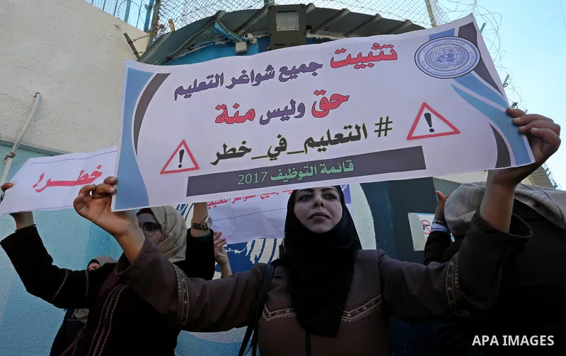 Palestinian employees of United Nations Relief and Works Agency (UNRWA) take part in a protest demanding their rights, outside its headquarter office, in Gaza City on November 25, 2018. Photo by Ashraf Amra