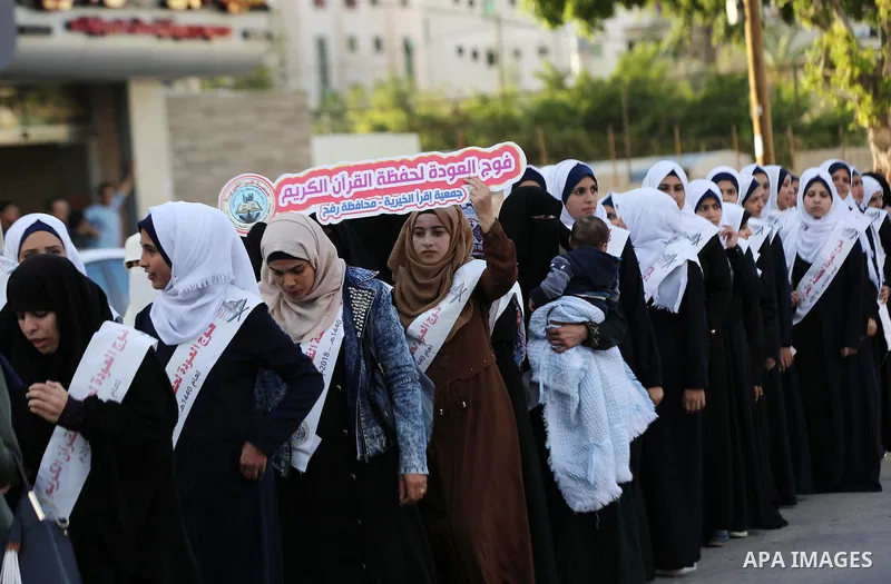 Palestinian females attend a religious ceremony after they completing the Koran education, organized by Islamic Jihad in Gaza City on November 25, 2018. Photo by Ashraf Amra