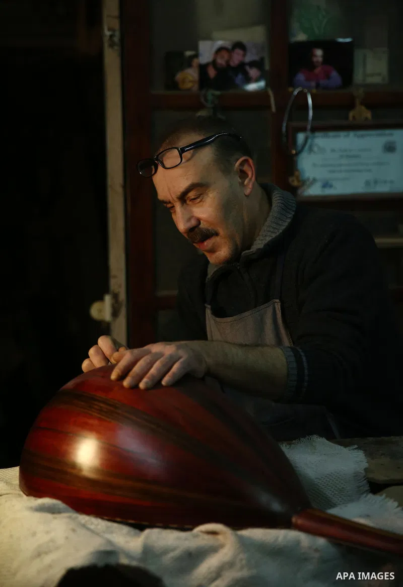 Palestinian nurse, Ali Hassanin, 57, who makes lutes, known in Arabic as an "Oud", works on a musical instrument, at his workshop, in the West Bank city of Nablus on November 26, 2018. Photo by Shadi Jarar'ah