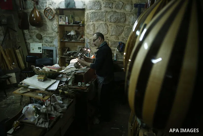 Palestinian nurse, Ali Hassanin, 57, who makes lutes, known in Arabic as an "Oud", works on a musical instrument, at his workshop, in the West Bank city of Nablus on November 26, 2018. Photo by Shadi Jarar'ah