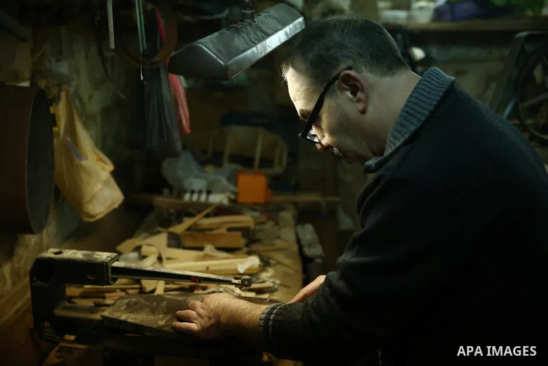 Palestinian nurse, Ali Hassanin, 57, who makes lutes, known in Arabic as an "Oud", works on a musical instrument, at his workshop, in the West Bank city of Nablus on November 26, 2018. Photo by Shadi Jarar'ah