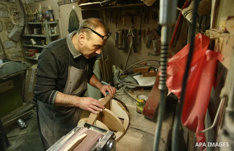 Palestinian nurse, Ali Hassanin, 57, who makes lutes, known in Arabic as an "Oud", works on a musical instrument, at his workshop, in the West Bank city of Nablus on November 26, 2018. Photo by Shadi Jarar'ah