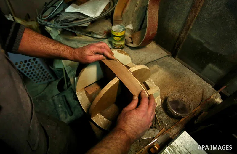 Palestinian nurse, Ali Hassanin, 57, who makes lutes, known in Arabic as an "Oud", works on a musical instrument, at his workshop, in the West Bank city of Nablus on November 26, 2018. Photo by Shadi Jarar'ah