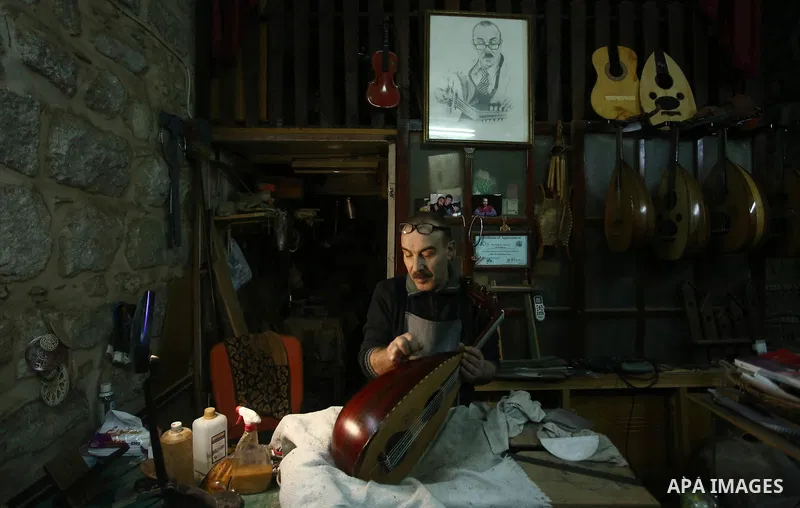 Palestinian nurse, Ali Hassanin, 57, who makes lutes, known in Arabic as an "Oud", works on a musical instrument, at his workshop, in the West Bank city of Nablus on November 26, 2018. Photo by Shadi Jarar'ah