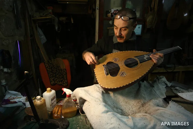 Palestinian nurse, Ali Hassanin, 57, who makes lutes, known in Arabic as an "Oud", works on a musical instrument, at his workshop, in the West Bank city of Nablus on November 26, 2018. Photo by Shadi Jarar'ah