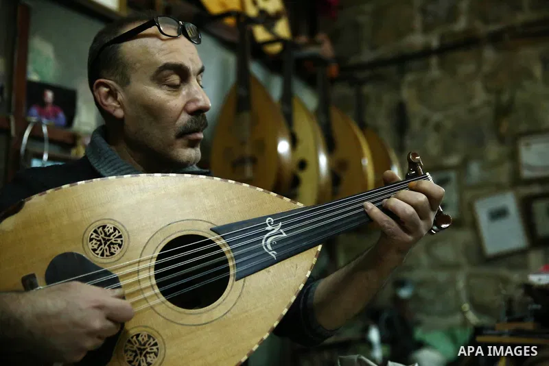 Palestinian nurse, Ali Hassanin, 57, who makes lutes, known in Arabic as an "Oud", works on a musical instrument, at his workshop, in the West Bank city of Nablus on November 26, 2018. Photo by Shadi Jarar'ah