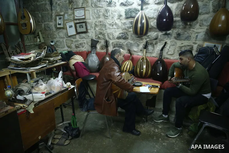 Palestinian nurse, Ali Hassanin, 57, who makes lutes, known in Arabic as an "Oud", works on a musical instrument, at his workshop, in the West Bank city of Nablus on November 26, 2018. Photo by Shadi Jarar'ah
