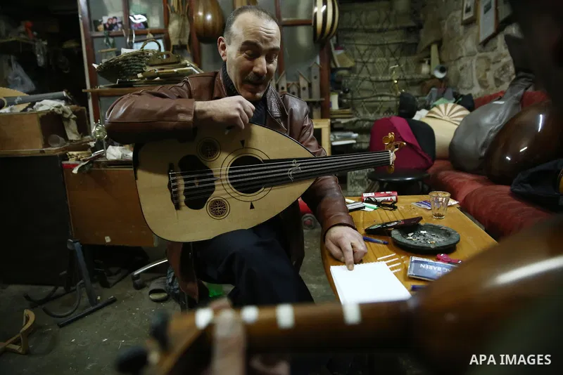 Palestinian nurse, Ali Hassanin, 57, who makes lutes, known in Arabic as an "Oud", works on a musical instrument, at his workshop, in the West Bank city of Nablus on November 26, 2018. Photo by Shadi Jarar'ah