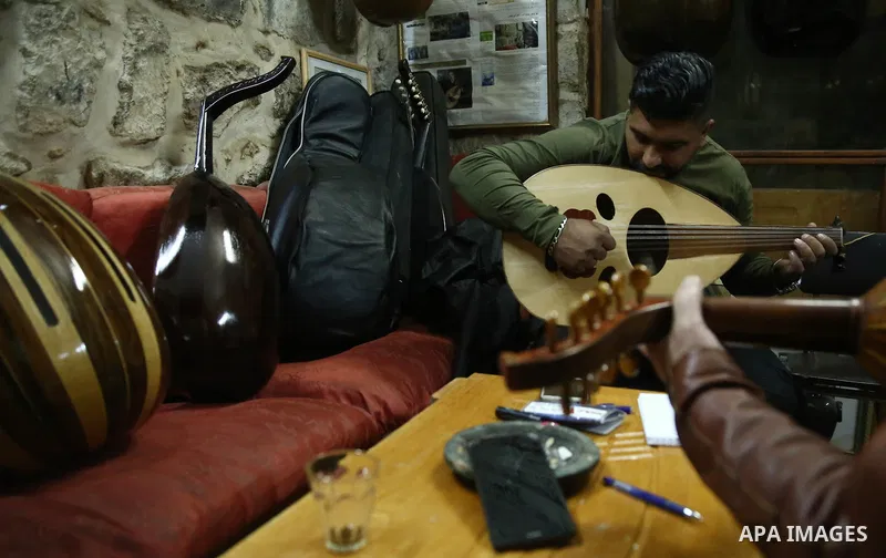 Palestinian nurse, Ali Hassanin, 57, who makes lutes, known in Arabic as an "Oud", works on a musical instrument, at his workshop, in the West Bank city of Nablus on November 26, 2018. Photo by Shadi Jarar'ah