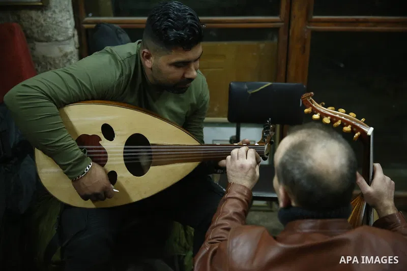 Palestinian nurse, Ali Hassanin, 57, who makes lutes, known in Arabic as an "Oud", works on a musical instrument, at his workshop, in the West Bank city of Nablus on November 26, 2018. Photo by Shadi Jarar'ah
