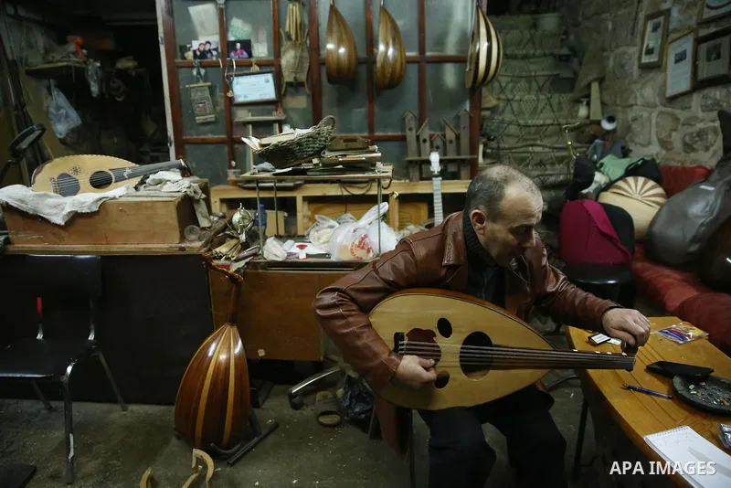 Palestinian nurse, Ali Hassanin, 57, who makes lutes, known in Arabic as an "Oud", works on a musical instrument, at his workshop, in the West Bank city of Nablus on November 26, 2018. Photo by Shadi Jarar'ah