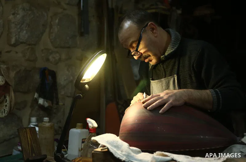 Palestinian nurse, Ali Hassanin, 57, who makes lutes, known in Arabic as an "Oud", works on a musical instrument, at his workshop, in the West Bank city of Nablus on November 26, 2018. Photo by Shadi Jarar'ah