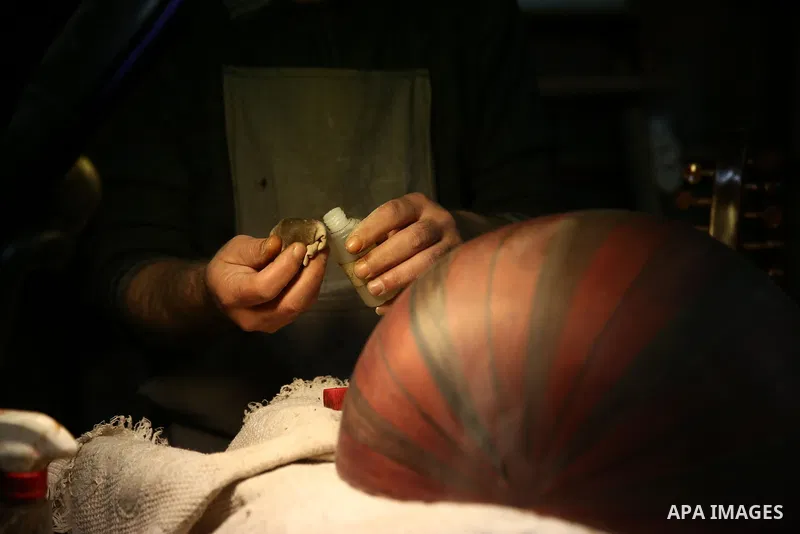 Palestinian nurse, Ali Hassanin, 57, who makes lutes, known in Arabic as an "Oud", works on a musical instrument, at his workshop, in the West Bank city of Nablus on November 26, 2018. Photo by Shadi Jarar'ah