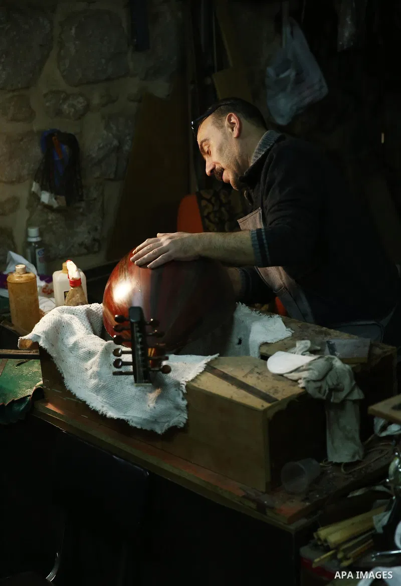 Palestinian nurse, Ali Hassanin, 57, who makes lutes, known in Arabic as an "Oud", works on a musical instrument, at his workshop, in the West Bank city of Nablus on November 26, 2018. Photo by Shadi Jarar'ah