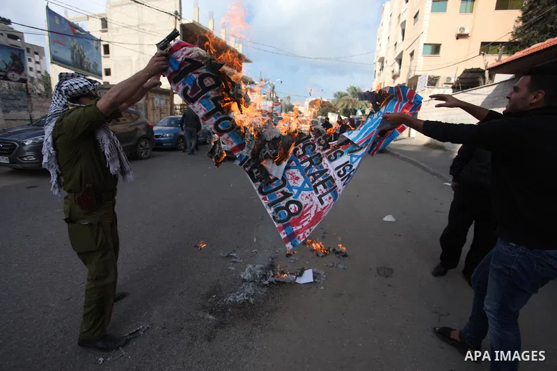 Palestinians burn an Israeli, British and U.S. flags during a protest to show solidarity with Palestinian prisoners held in Israeli jails, in front of Red cross office in Gaza city, on November, 26, 2018. Photo by Mahmou...