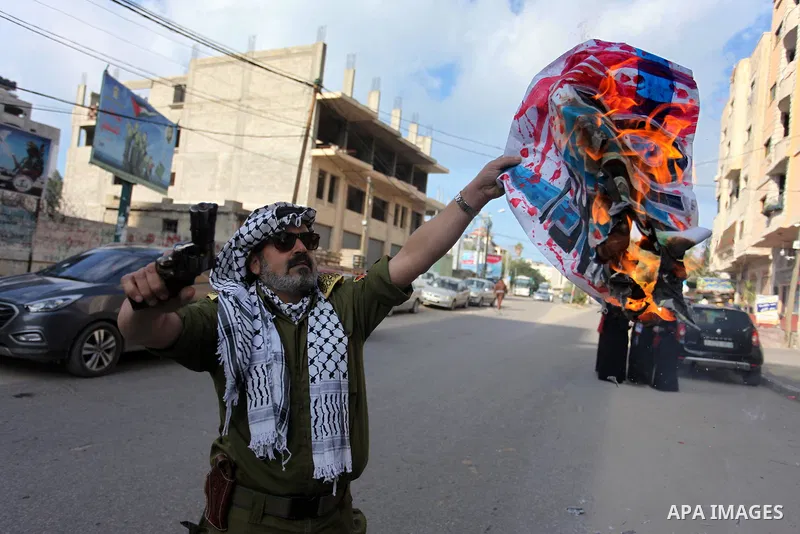 Palestinians burn an Israeli, British and U.S. flags during a protest to show solidarity with Palestinian prisoners held in Israeli jails, in front of Red cross office in Gaza city, on November, 26, 2018. Photo by Mahmou...