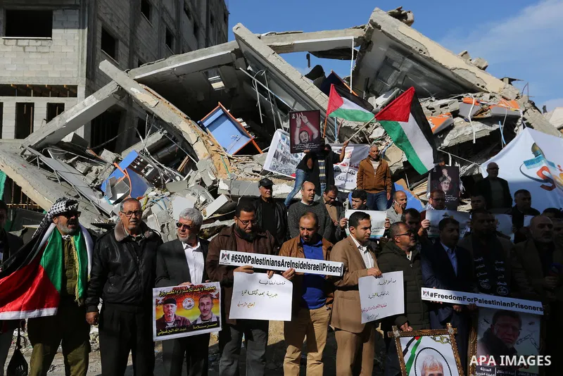 Palestinians take part during a protest against targeting of the television station al-Aqsa TV which was destroyed by Israeli air strikes in Gaza City on November 26, 2018. Photo by Ashraf Amra