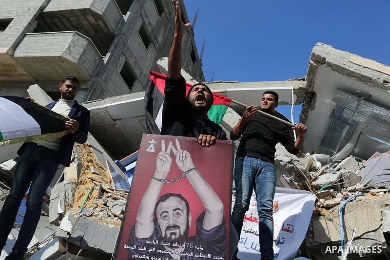 Palestinians take part during a protest against targeting of the television station al-Aqsa TV which was destroyed by Israeli air strikes in Gaza City on November 26, 2018. Photo by Ashraf Amra