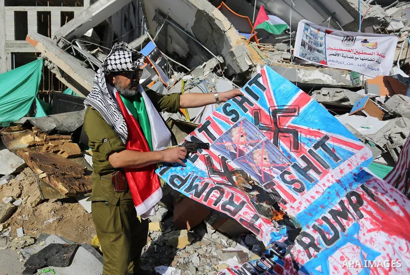 Palestinians take part during a protest against targeting of the television station al-Aqsa TV which was destroyed by Israeli air strikes in Gaza City on November 26, 2018. Photo by Ashraf Amra