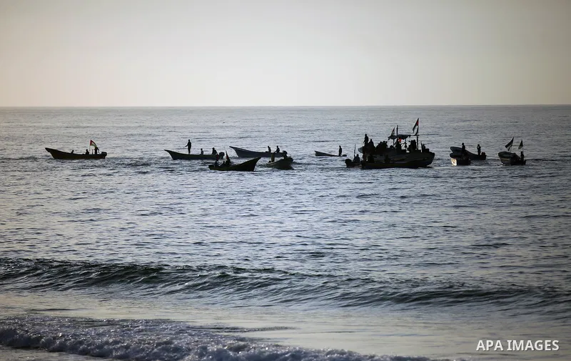 Palestinian protesters sail with boats during a demonstration against the Israeli blockade on Gaza Strip, along the Gaza sea barrier on the maritime border with Israel near Kibbutz Zikim, north of Beit Lahia in the north...
