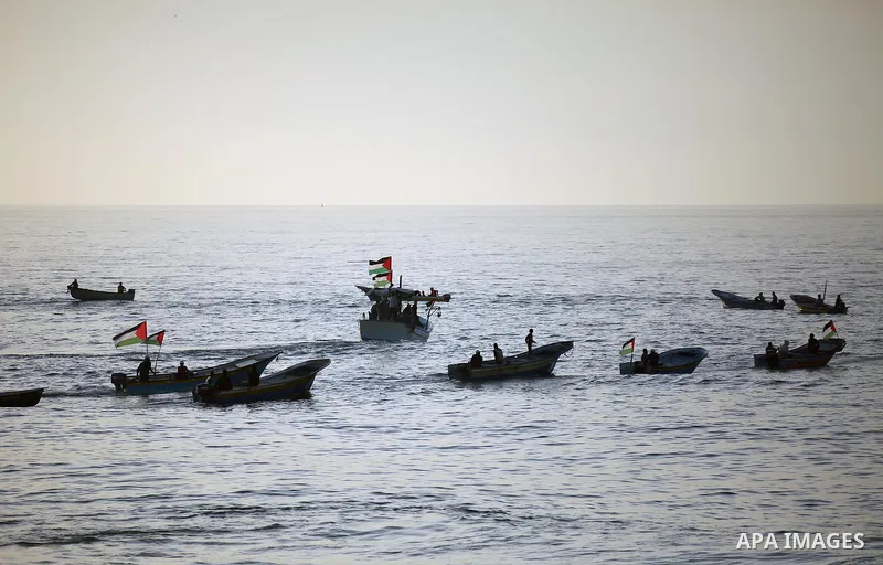 Palestinian protesters sail with boats during a demonstration against the Israeli blockade on Gaza Strip, along the Gaza sea barrier on the maritime border with Israel near Kibbutz Zikim, north of Beit Lahia in the north...