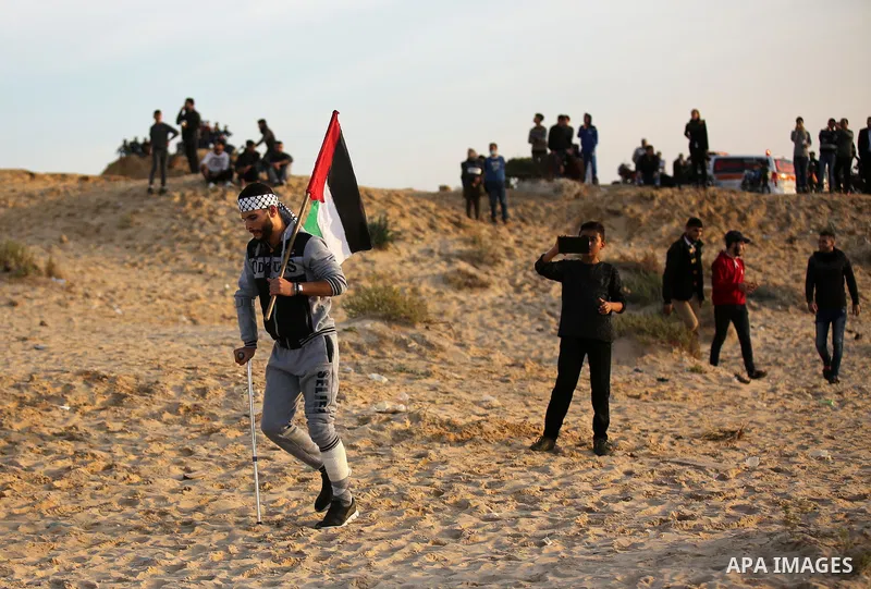 Palestinian protesters gather during clashes with Israeli forces in a demonstration against the Israeli blockade on Gaza Strip, along the Gaza sea barrier on the maritime border with Israel near Kibbutz Zikim, north of B...