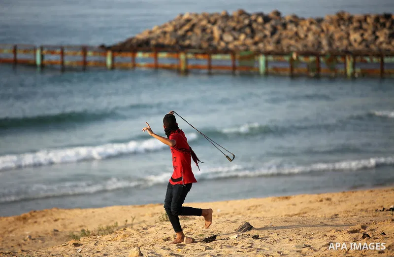 Palestinian protesters gather during clashes with Israeli forces in a demonstration against the Israeli blockade on Gaza Strip, along the Gaza sea barrier on the maritime border with Israel near Kibbutz Zikim, north of B...