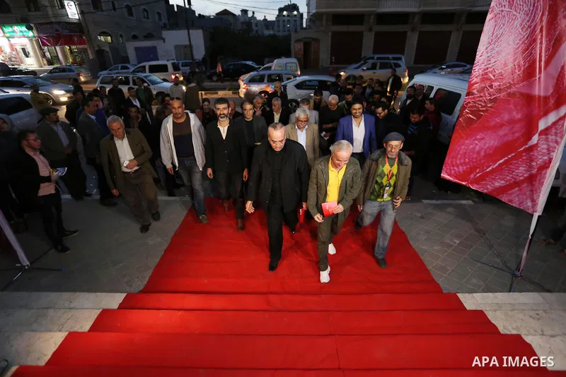 Palestinians walk on a red carpet during 4th Annual Red Carpet Festival for Human Rights Films in Gaza City on November 26, 2018. The Red Carpet Festival is held in the Gaza Strip for the fourth year in a raw with the Ha...