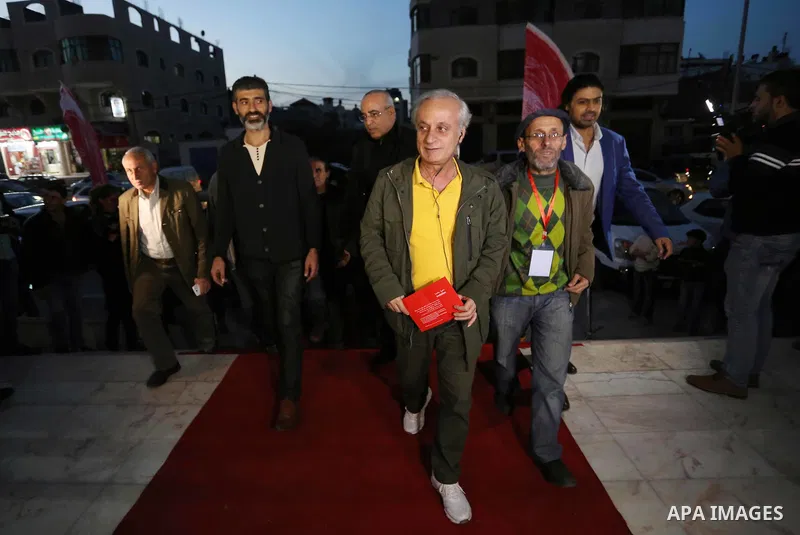 Palestinians walk on a red carpet during 4th Annual Red Carpet Festival for Human Rights Films in Gaza City on November 26, 2018. The Red Carpet Festival is held in the Gaza Strip for the fourth year in a raw with the Ha...
