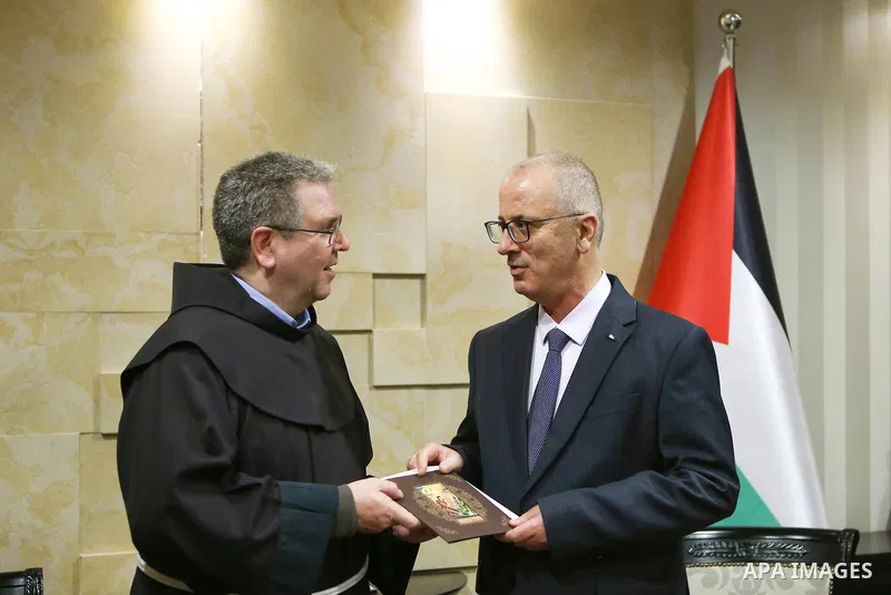 Palestinian Prime Minister Rami Hamdallah, receives an invitation to attend the Midnight Mass for the Western calendar in the West Bank city of Ramallah on November 28, 2018. Photo by Prime Minister Office