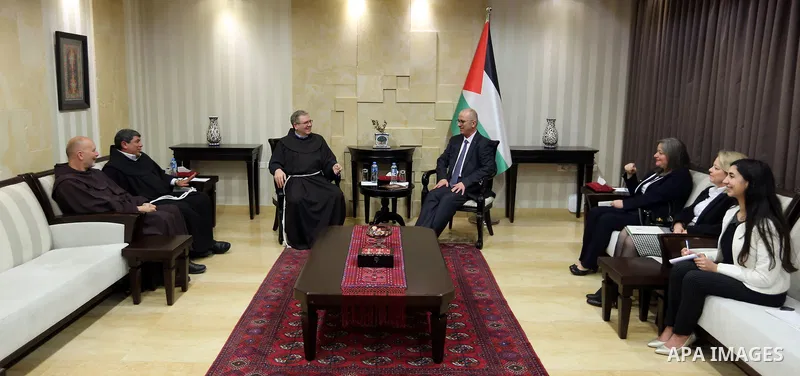 Palestinian Prime Minister Rami Hamdallah, receives an invitation to attend the Midnight Mass for the Western calendar in the West Bank city of Ramallah on November 28, 2018. Photo by Prime Minister Office