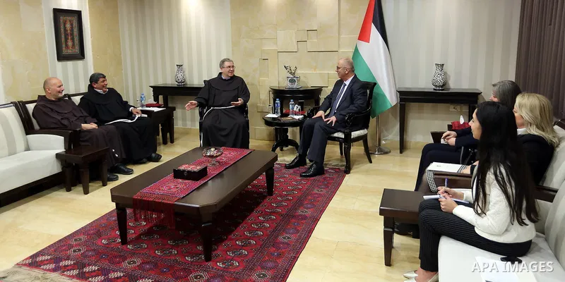 Palestinian Prime Minister Rami Hamdallah, receives an invitation to attend the Midnight Mass for the Western calendar in the West Bank city of Ramallah on November 28, 2018. Photo by Prime Minister Office