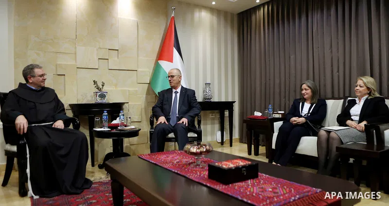 Palestinian Prime Minister Rami Hamdallah, receives an invitation to attend the Midnight Mass for the Western calendar in the West Bank city of Ramallah on November 28, 2018. Photo by Prime Minister Office
