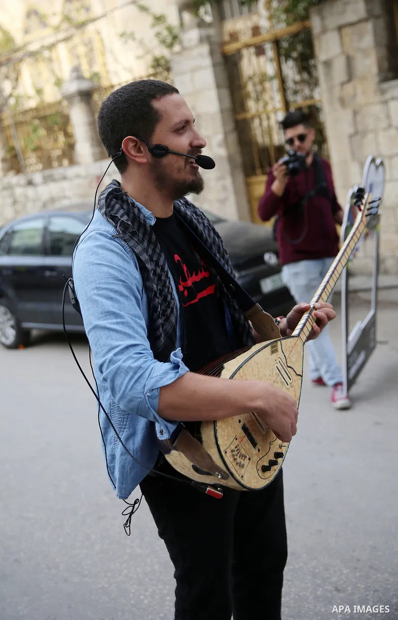Palestinian musical band play music at street during a street carnival in the West Bank city of Nablus on November 28, 2018. Photo by Shadi Jarar'ah