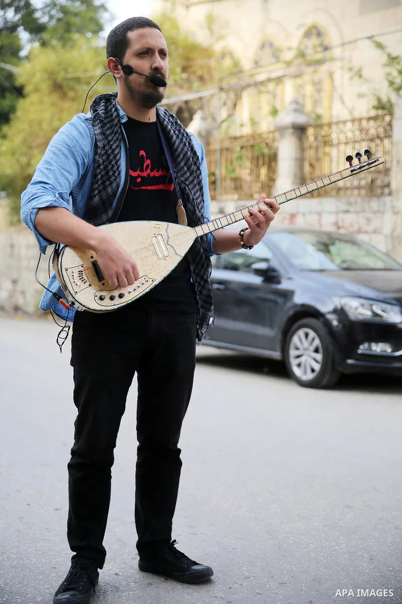 Palestinian musical band play music at street during a street carnival in the West Bank city of Nablus on November 28, 2018. Photo by Shadi Jarar'ah