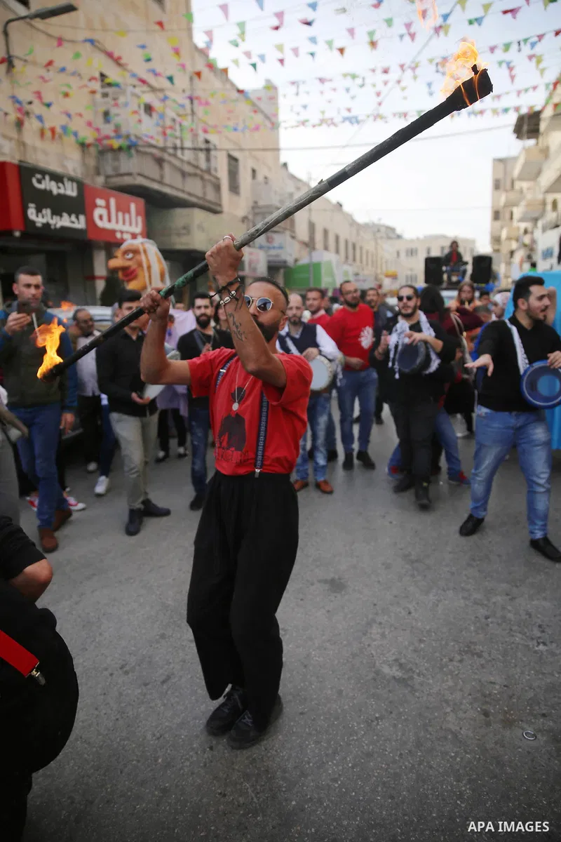 Palestinian clowns perform at street during a street carnival in the West Bank city of Nablus on November 28, 2018. Photo by Shadi Jarar'ah