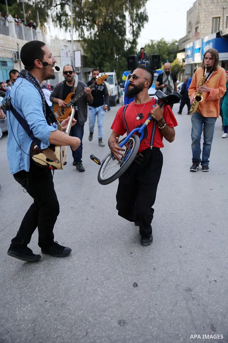 Palestinian musical band play music at street during a street carnival in the West Bank city of Nablus on November 28, 2018. Photo by Shadi Jarar'ah