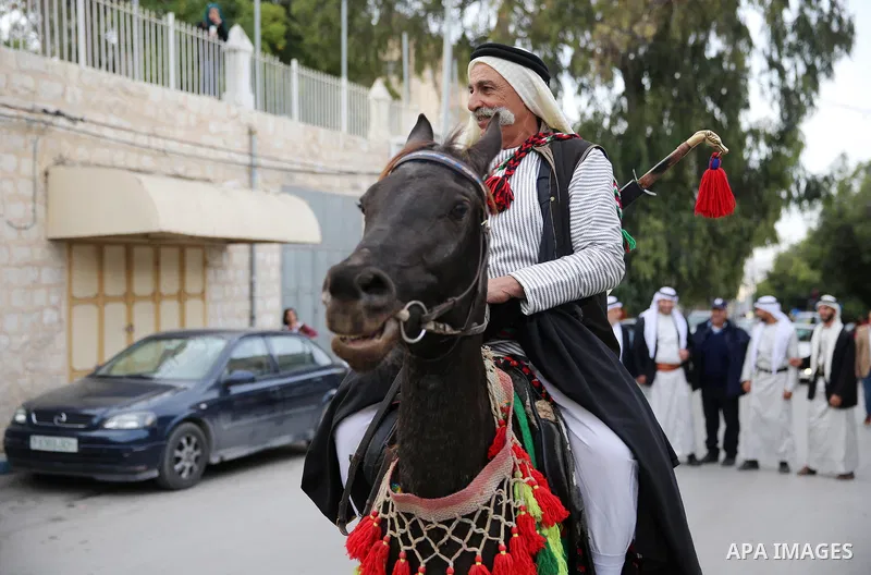 A Palestinian man rides a horse at street during a street carnival in the West Bank city of Nablus on November 28, 2018. Photo by Shadi Jarar'ah