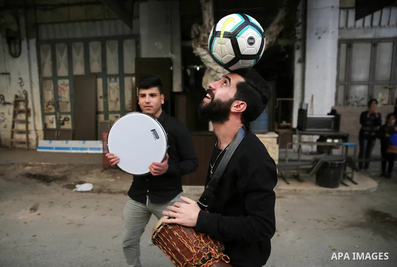 Palestinian musical band play music at street during a street carnival in the West Bank city of Nablus on November 28, 2018. Photo by Shadi Jarar'ah