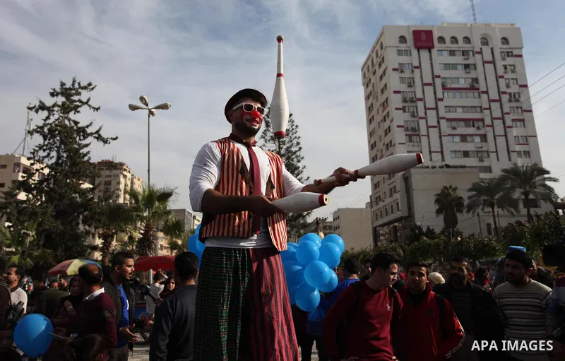 Palestinian clowns perform at street during a street carnival in Gaza city, on November 29, 2018. Photo by Mahmoud Ajjour