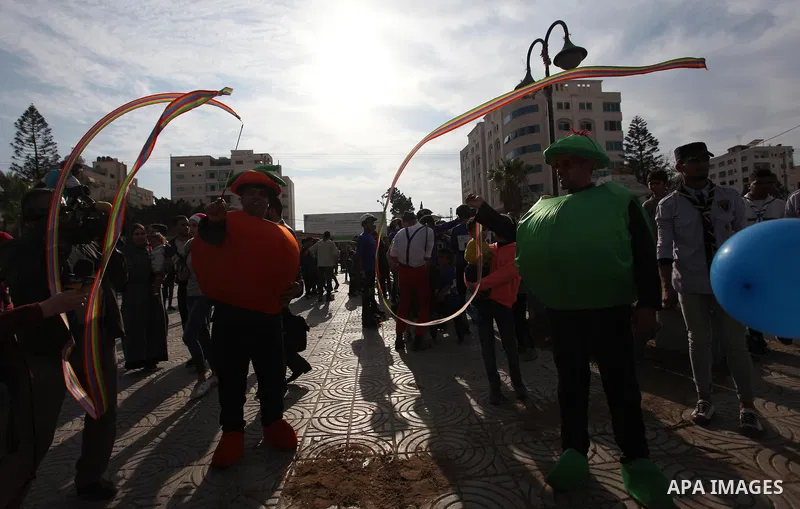 Palestinian clowns perform at street during a street carnival in Gaza city, on November 29, 2018. Photo by Mahmoud Ajjour