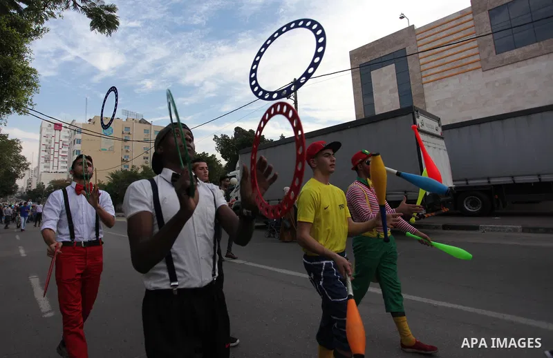 Palestinian clowns perform at street during a street carnival in Gaza city, on November 29, 2018. Photo by Mahmoud Ajjour