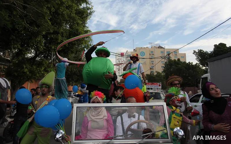 Palestinian clowns perform at street during a street carnival in Gaza city, on November 29, 2018. Photo by Mahmoud Ajjour