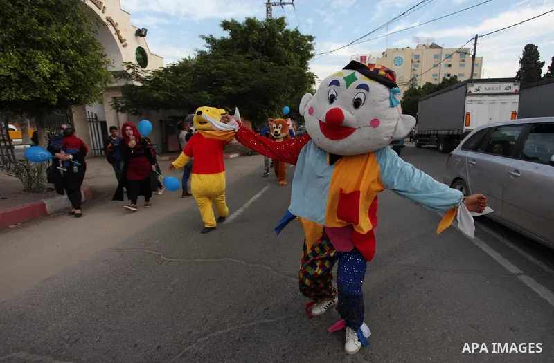Palestinian clowns perform at street during a street carnival in Gaza city, on November 29, 2018. Photo by Mahmoud Ajjour