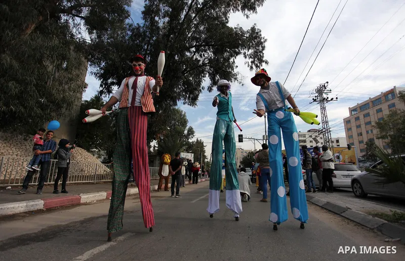 Palestinian clowns perform at street during a street carnival in Gaza city, on November 29, 2018. Photo by Mahmoud Ajjour