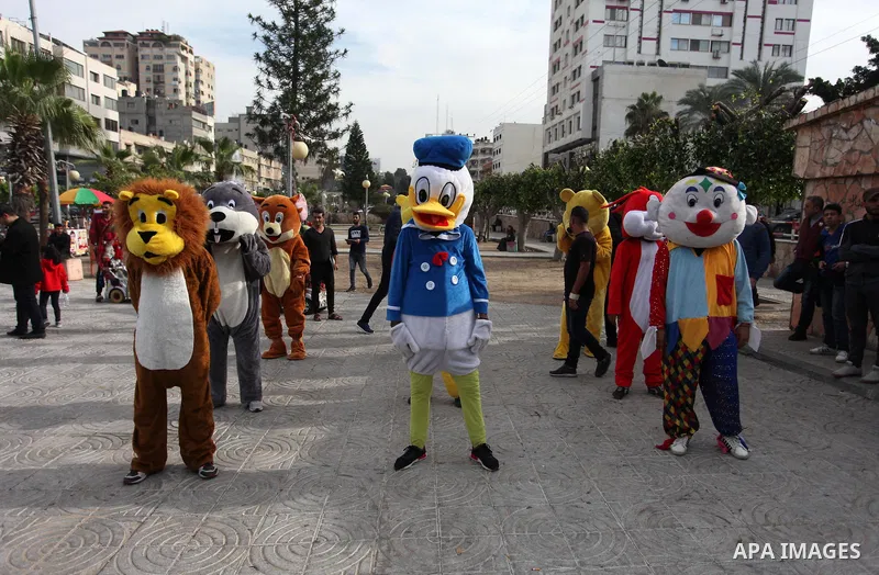 Palestinian clowns perform at street during a street carnival in Gaza city, on November 29, 2018. Photo by Mahmoud Ajjour