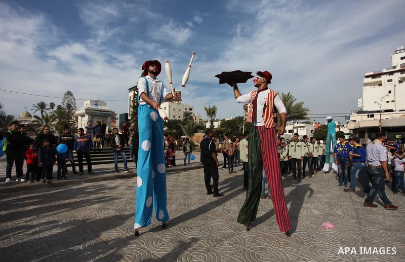Palestinian clowns perform at street during a street carnival in Gaza city, on November 29, 2018. Photo by Mahmoud Ajjour