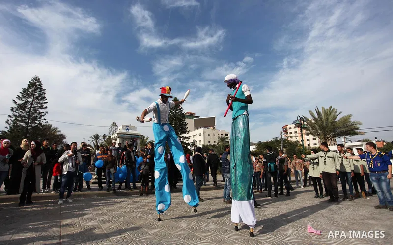 Palestinian clowns perform at street during a street carnival in Gaza city, on November 29, 2018. Photo by Mahmoud Ajjour