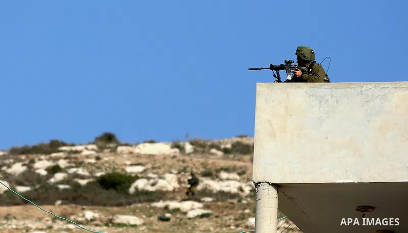 Israeli forces take position during clashes with Palestinian protesters during clashes following a weekly demonstration against the expropriation of Palestinian land by Israel in the village of Kfar Qaddum, near the West...